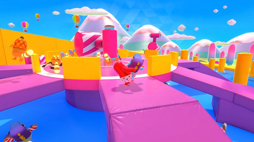 Colorful Fall Guys characters dodge pink hammers on a vibrant pink yellow obstacle course background Wallpaper