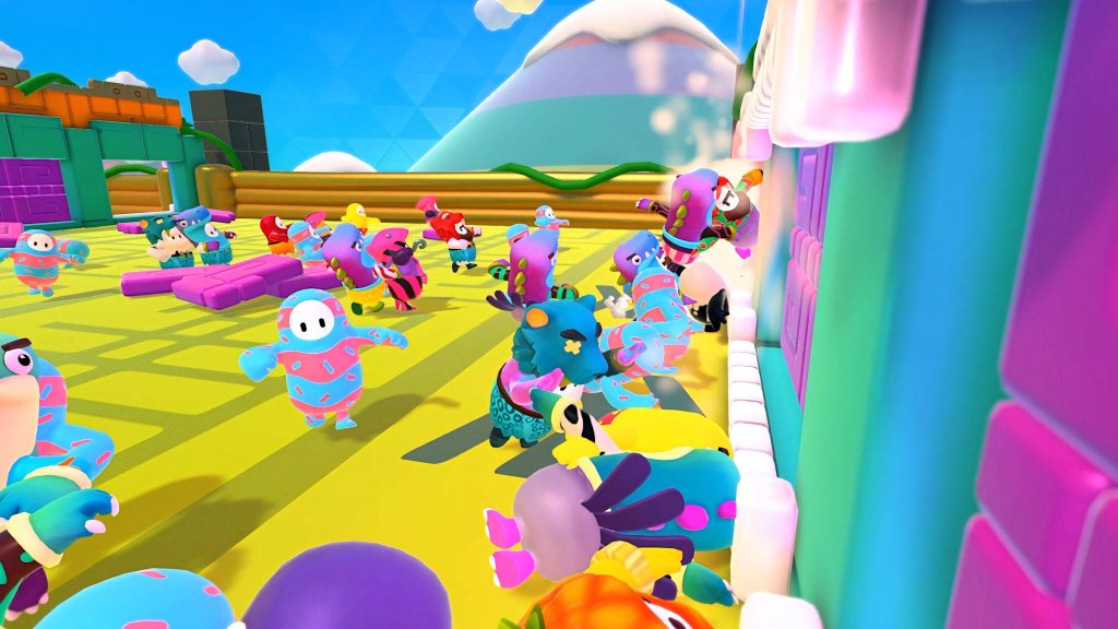Fall Guys players in colorful costumes race on bright yellow obstacle course with pink doors Wallpaper