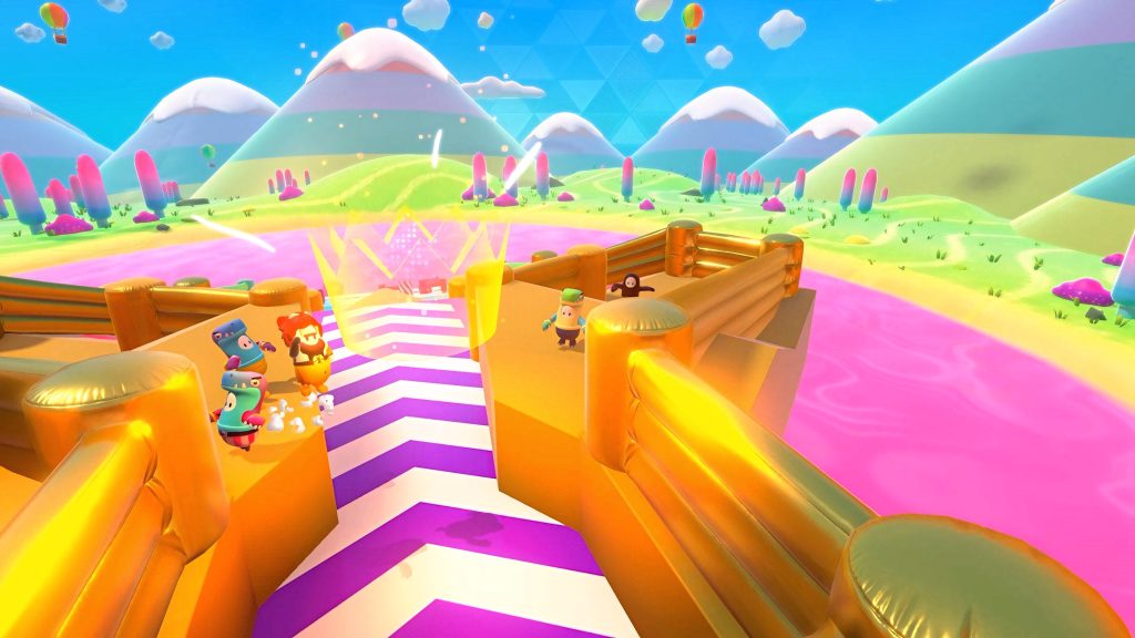 Fall Guys Ultimate Knockout vibrant wallpaper with costumed racers colorful map and snowy mountains
