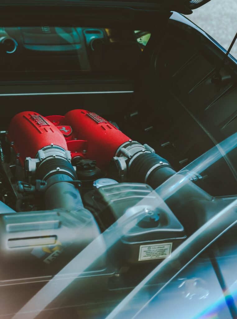 Close-Up Ferrari Engine Wallpaper: Intricate Design & Vibrant Red