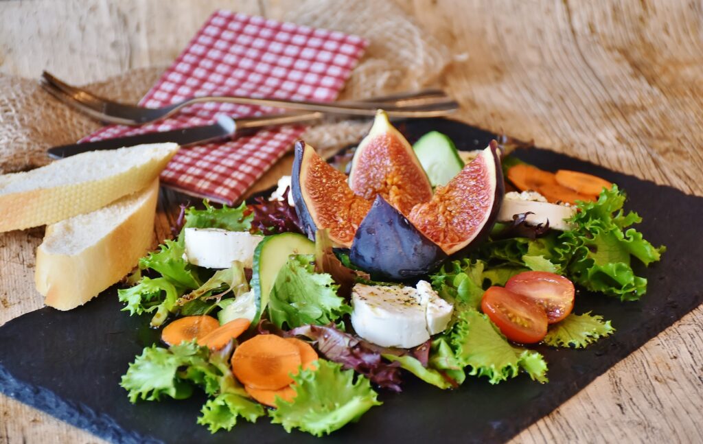 Vibrant Fresh Salad with Figs & Cherry Tomatoes on Slate Background Wallpaper