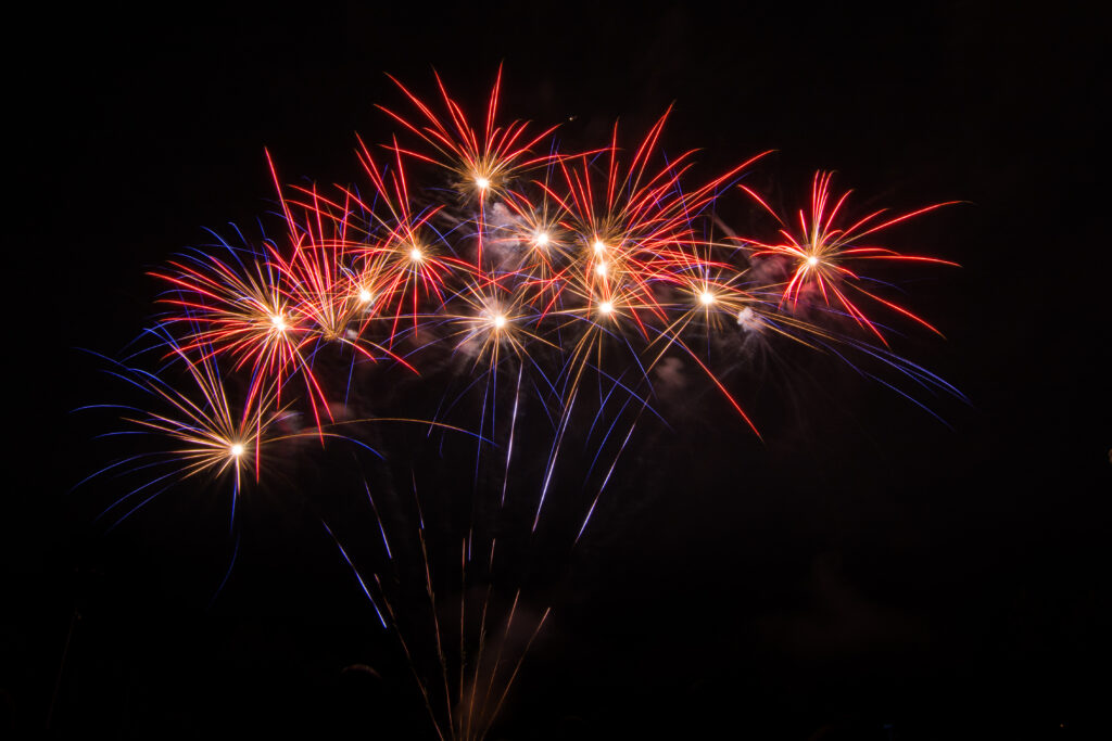 Vibrant Fireworks Night Sky Wallpaper Background - Stunning Glow