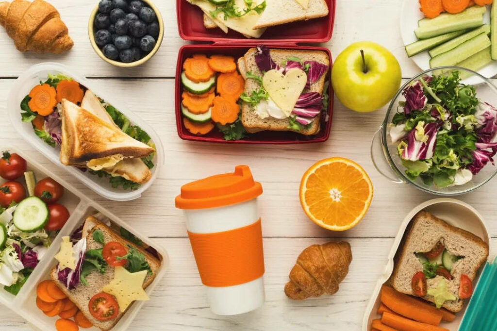Colorful Flat Lay of Healthy Lunch Boxes & Reusable Coffee Cup Wallpaper
