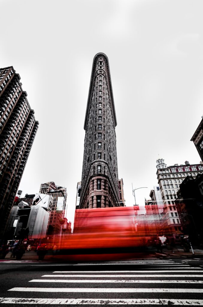 Dynamic Flatiron Building Wallpaper with Speeding Red Vehicle