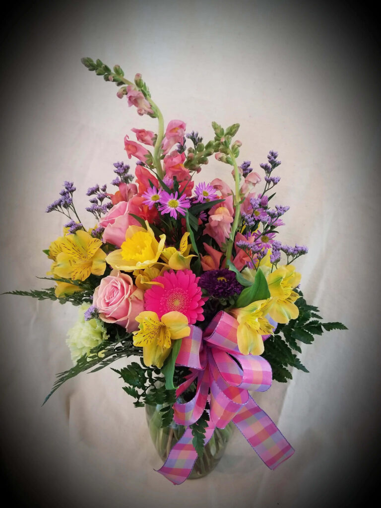 Colorful Floral Arrangement in Vase: Pink Roses, Daffodils & Greens Wallpaper