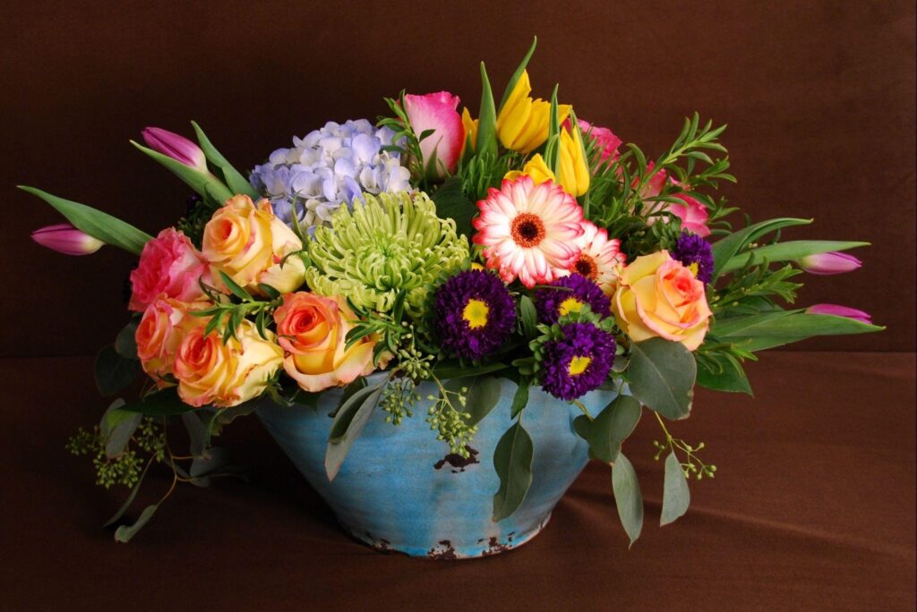 Vibrant Floral Wallpaper: Colorful Roses & Tulips in Rustic Pot