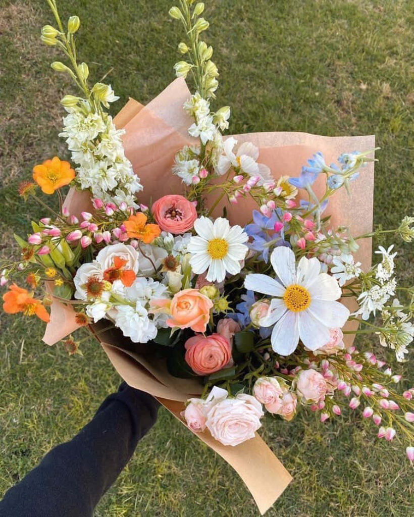 Vibrant Bouquet of Daisies, Roses & Wildflowers in Soft Brown Wrap Wallpaper