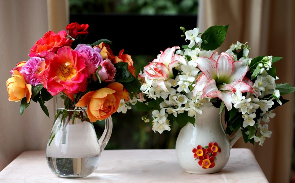Vibrant Flower Vases: Roses & Lilies in Serene Background Wallpaper