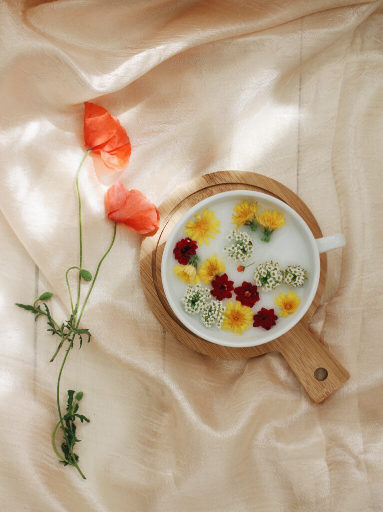 Tranquil Floral Wallpaper: Vibrant Flowers on Water with Textured Cloth