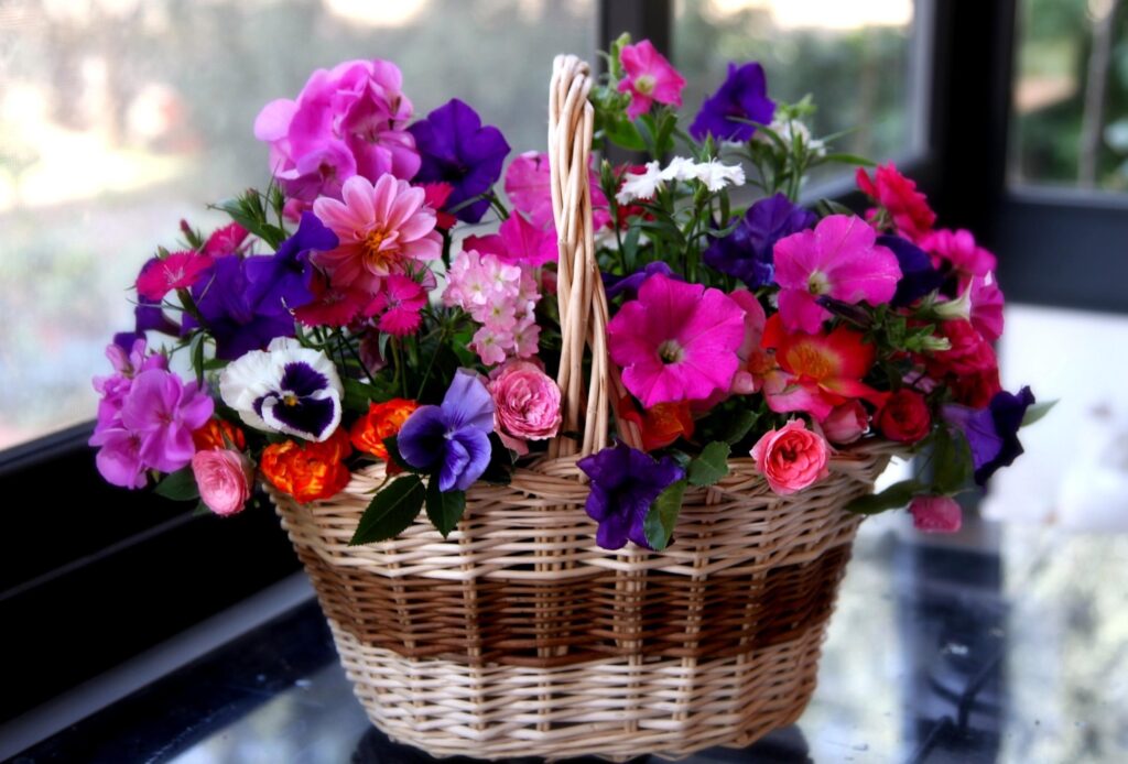 Cheerful Wicker Basket with Colorful Flowers Wallpaper