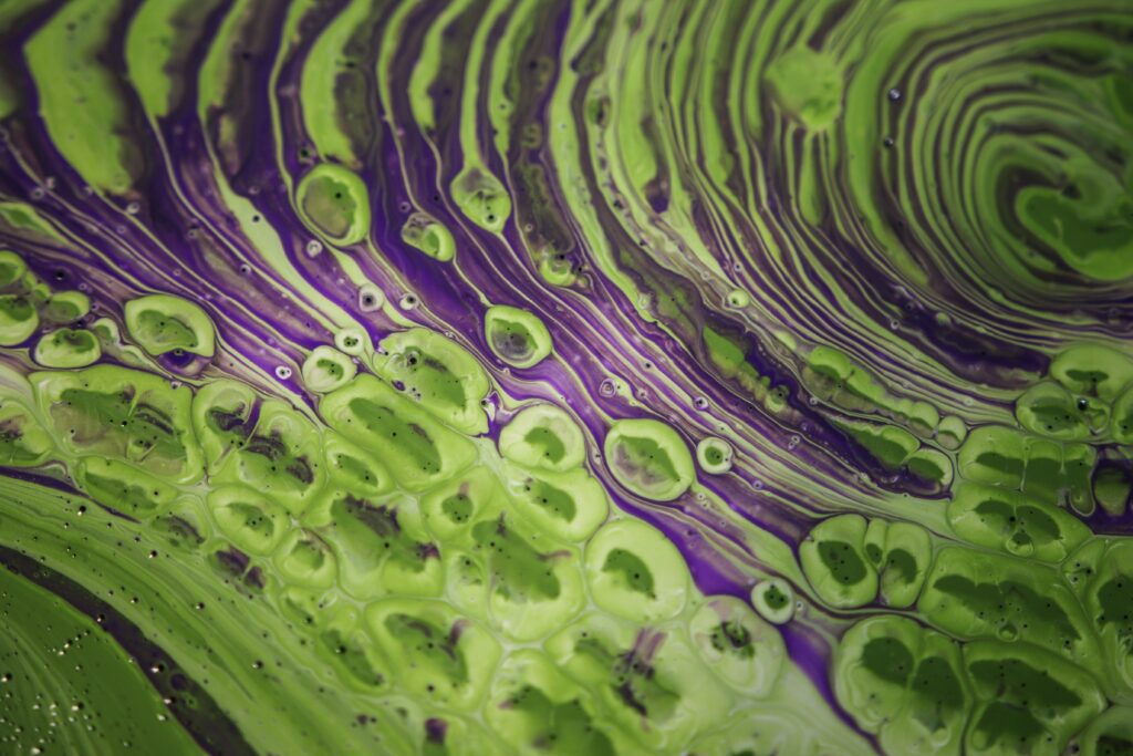 Mesmerizing Green and Purple Fluid Art Wallpaper Background