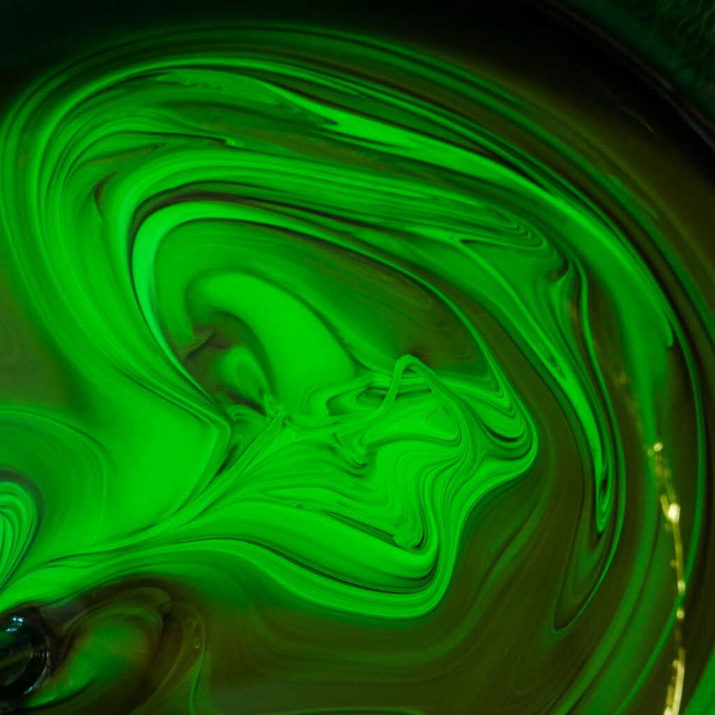 Dynamic Fluid Art Wallpaper: Swirling Green Abstract Background