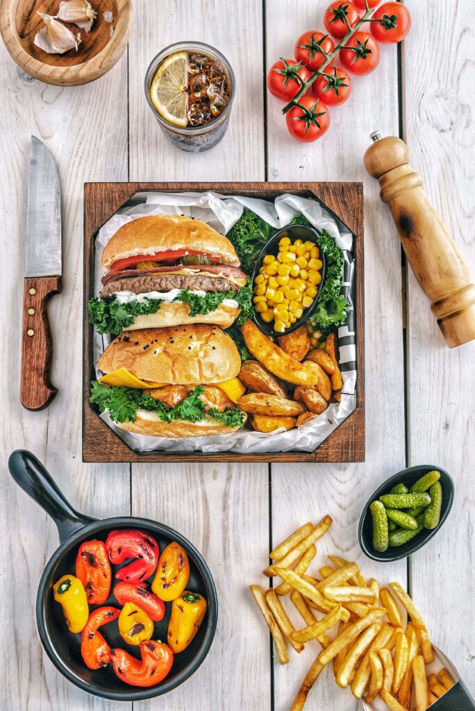 Vibrant Food Table: Delicious Hamburgers & Colorful Sides Wallpaper