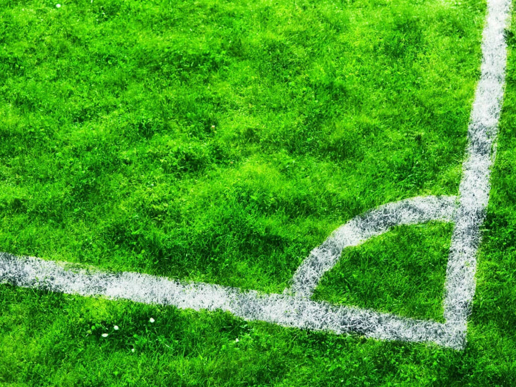 Vibrant Football Field Corner Arc - Bright Green Turf Wallpaper