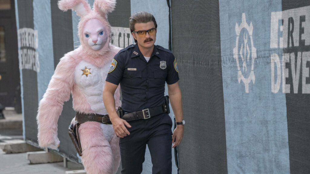 Quirky Free Guy Wallpaper: Rabbit Costume & Officer Duo
