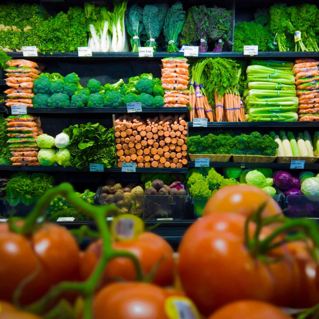 Vibrant Fresh Fruits and Veggies Wallpaper: Colorful Store Display