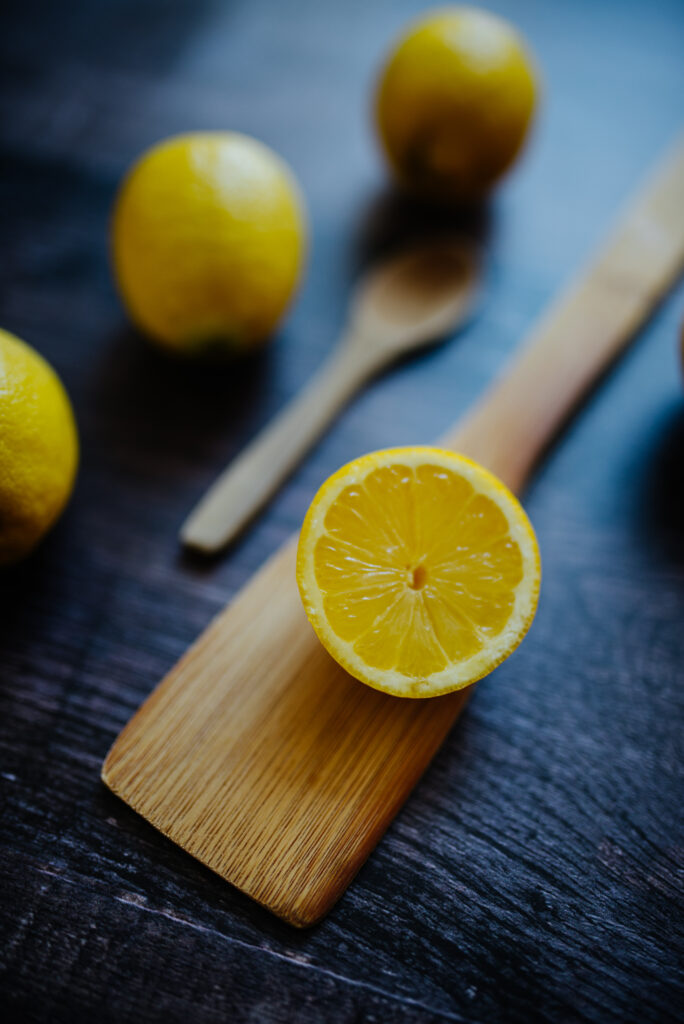 Rustic Lemon Wallpaper: Halved Citrus on Wooden Surface