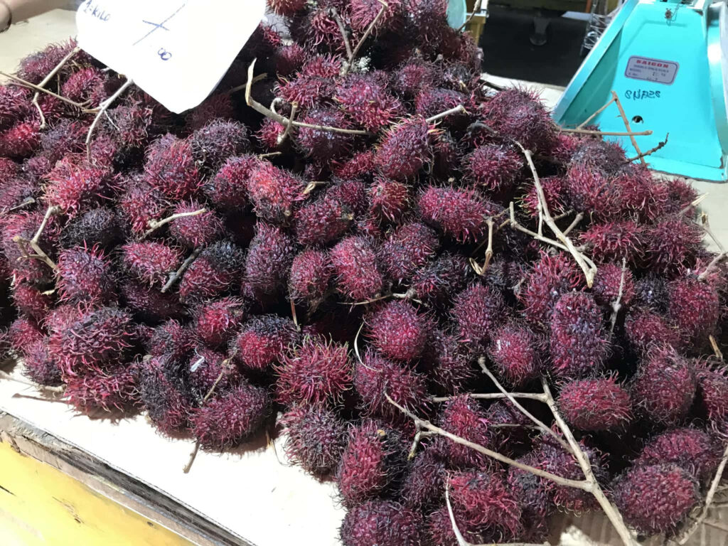 Vibrant Pulasan Fruits: Reddish Spiky Delights for Market Wallpaper