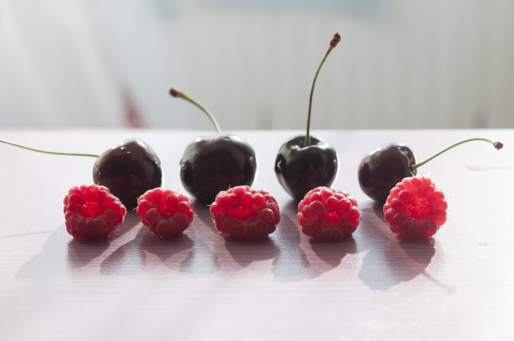 Fresh Raspberry and Cherry Wallpaper: Vibrant Fruit Reflections
