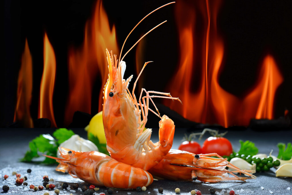 Vibrant Shrimp Garnished with Spices - Fiery Wallpaper Background