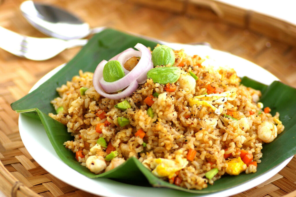 Colorful Fried Rice on Banana Leaf: Appetizing Wallpaper Background