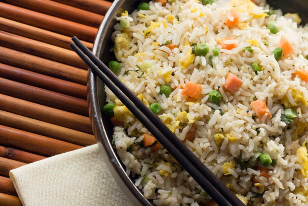Vibrant Fried Rice Bowl with Colorful Veggies & Black Chopsticks Wallpaper