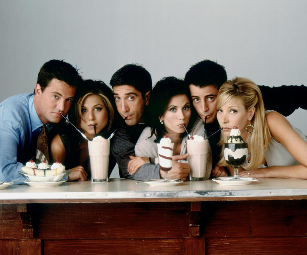 Friends Wallpaper: Iconic Cast Enjoying Milkshakes at a Diner