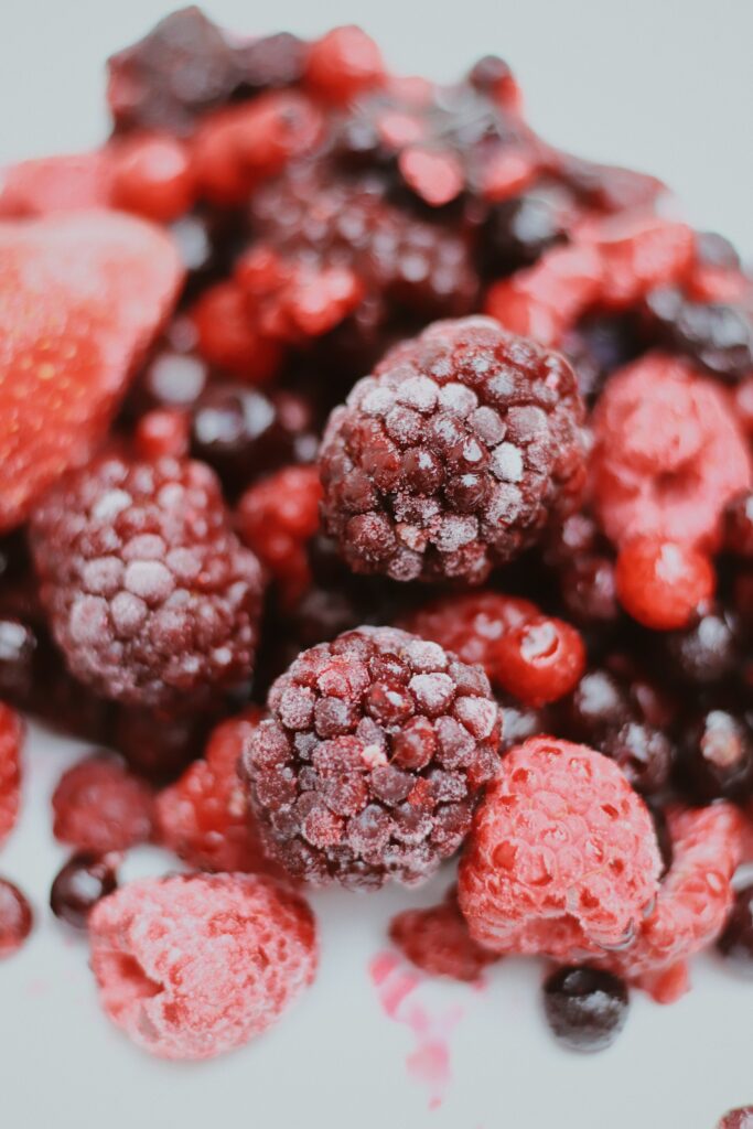 Vibrant Frozen Raspberries & Red Berries Macro Wallpaper Background