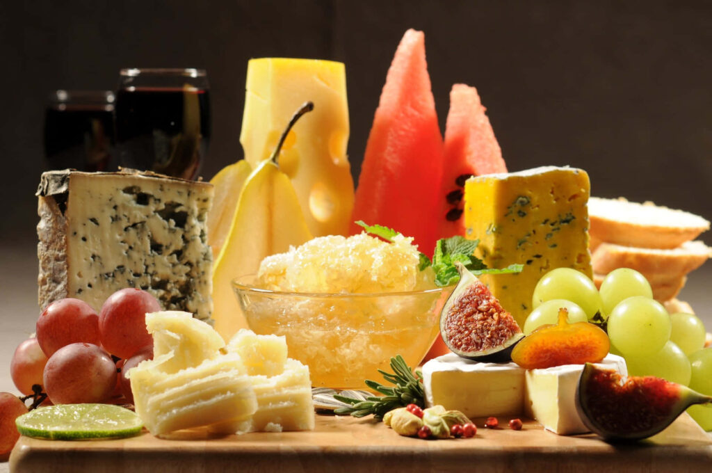 Vibrant Wallpaper: Fresh Fruits, Cheese & Wine Meal Display
