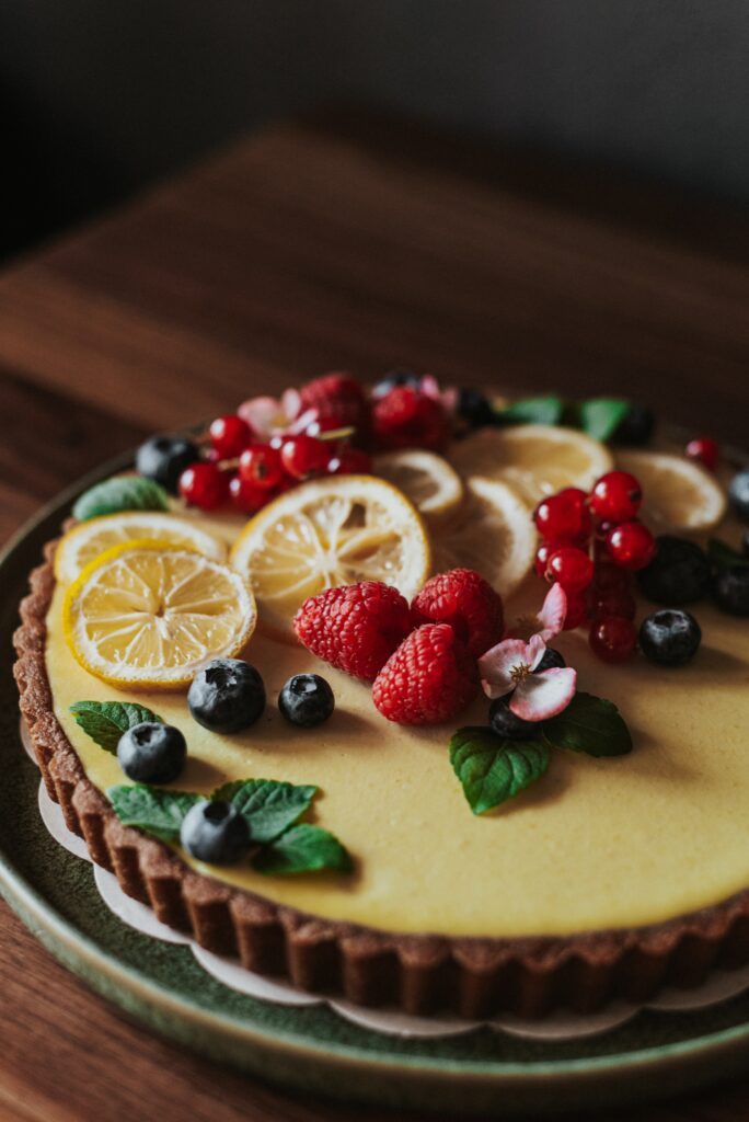 Vibrant Berry Fruit Tart on Rustic Wood - Wallpaper Background