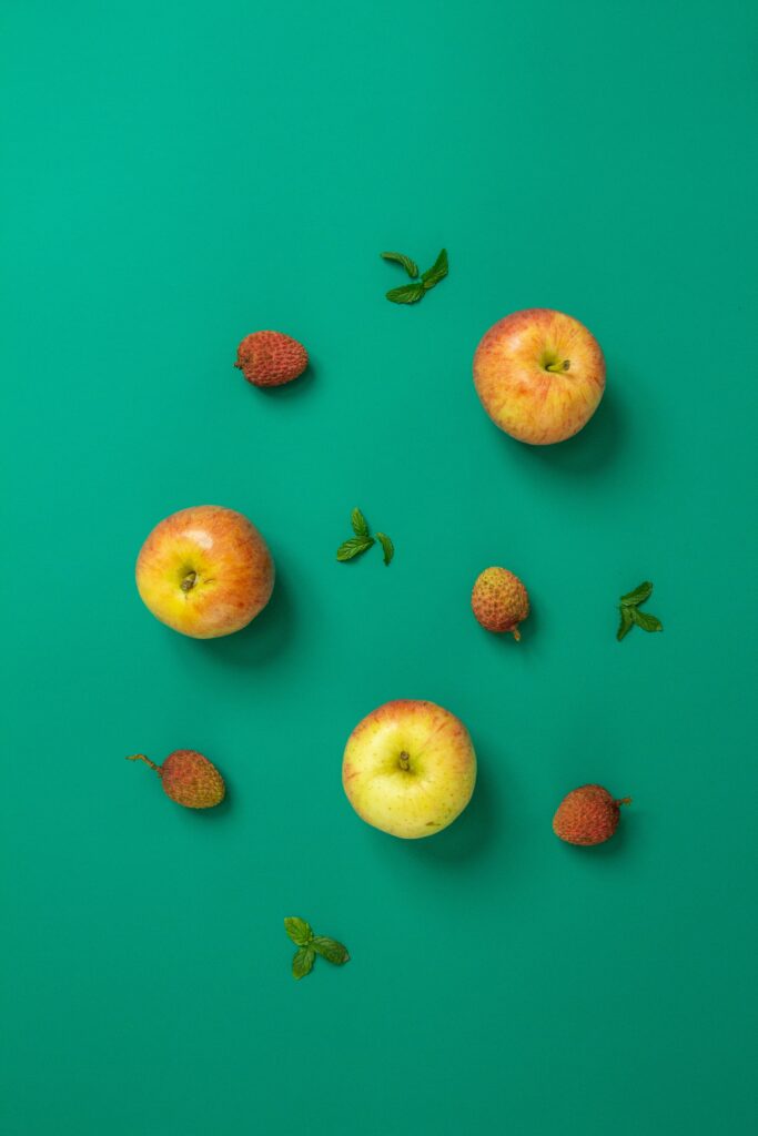 Colorful Fruit Wallpaper: Apples, Strawberries & Mint on Green