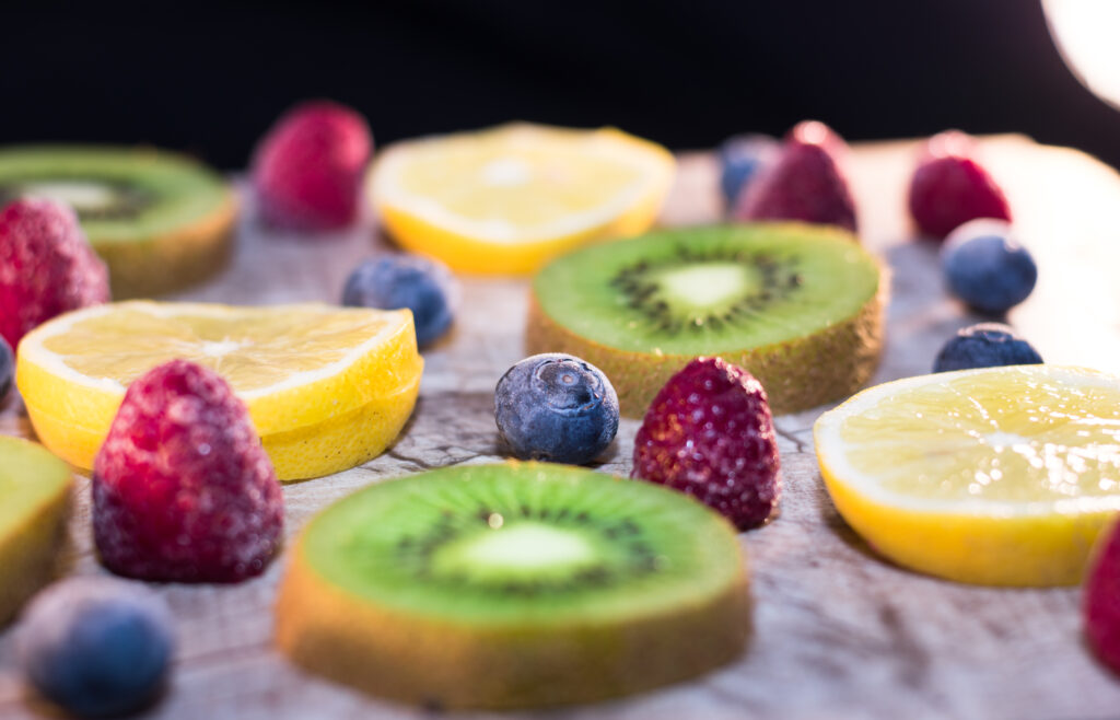 Vibrant Fruit Wallpaper: Fresh Kiwis, Lemons, and Berries Background