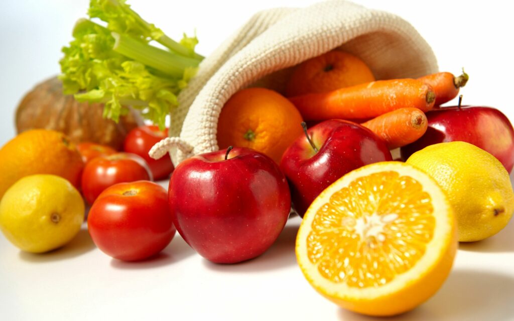 Vibrant Fruit & Veggie Display: Colorful Cloth Bag Wallpaper