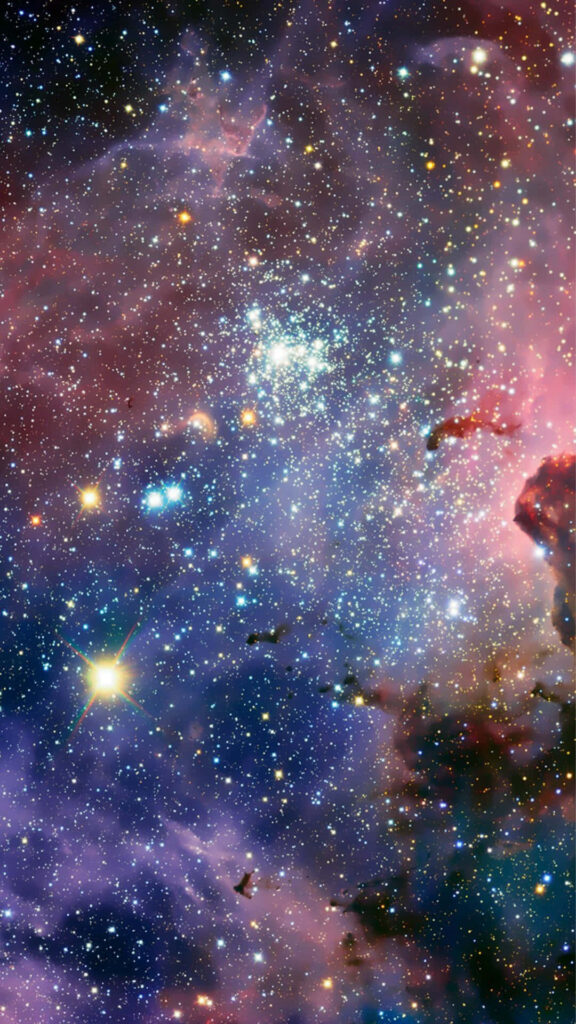 Vibrant galaxy wallpaper with colorful nebulae and twinkling stars, cosmic beauty backdrop.