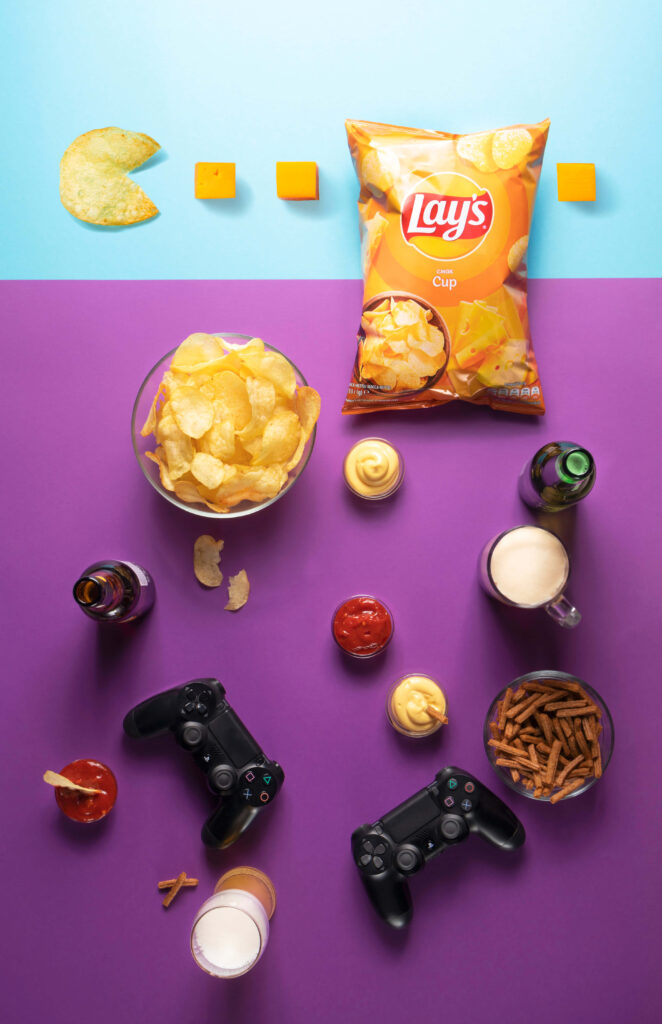 Colorful Gaming Setup Wallpaper: Snacks & Controllers Delight