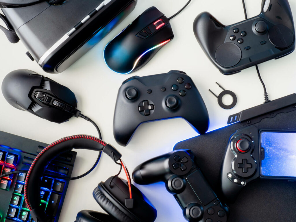 Vibrant Gaming Wallpaper: Controllers & Gadgets on White Background