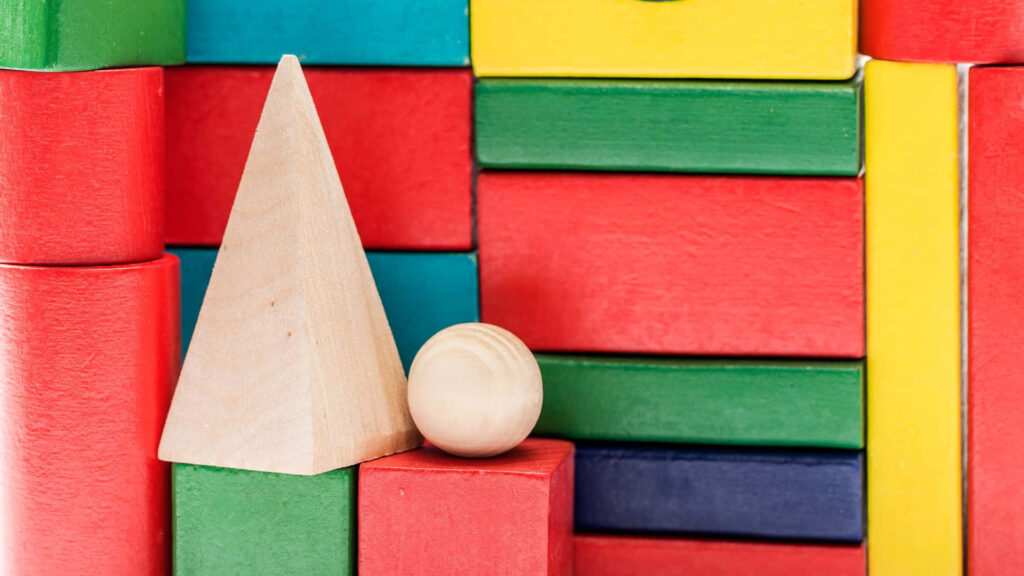 Vibrant Wooden Blocks in Geometric Shapes on Colorful Background Wallpaper