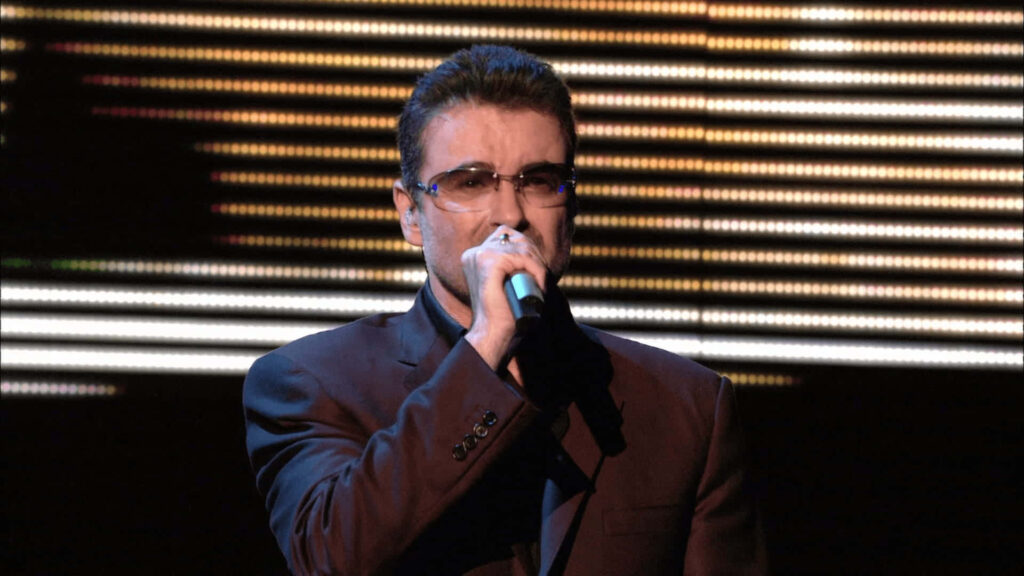 Vibrant George Michael Stage Performance Wallpaper Background