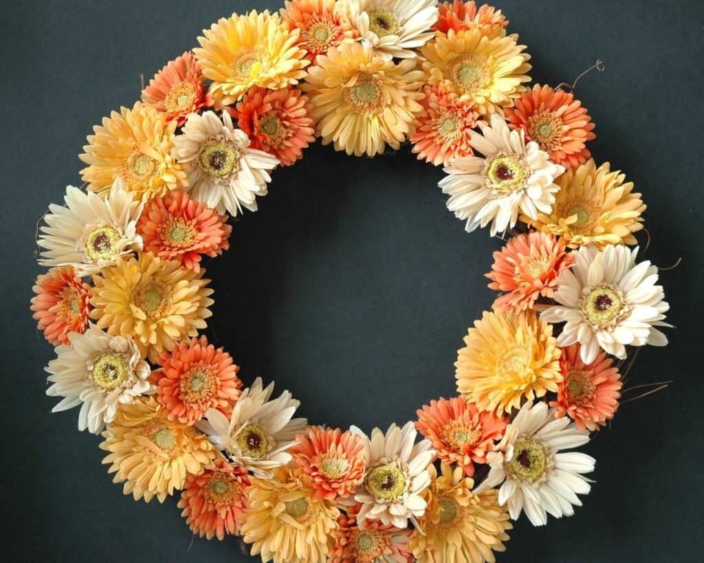 Vibrant Gerbera Flower Wreath Wallpaper on Dark Background