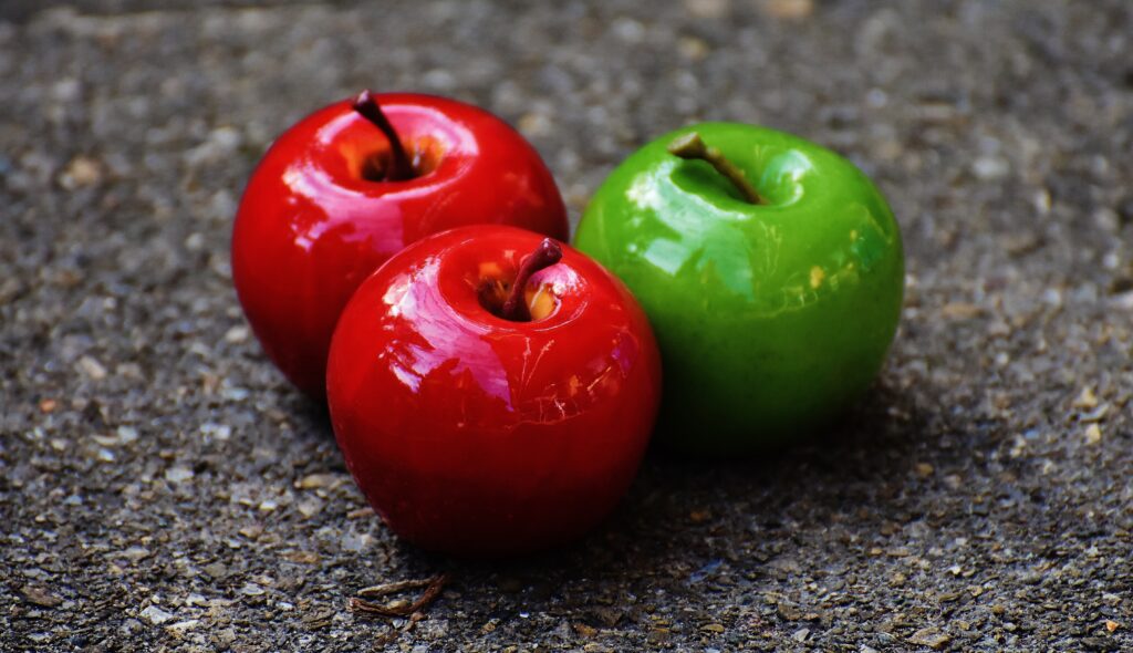 Vibrant Glossy Apples Wallpaper with Textured Background