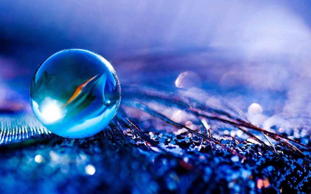 Vibrant Glowing Glass Ball Wallpaper Background with Soft Glare Effect