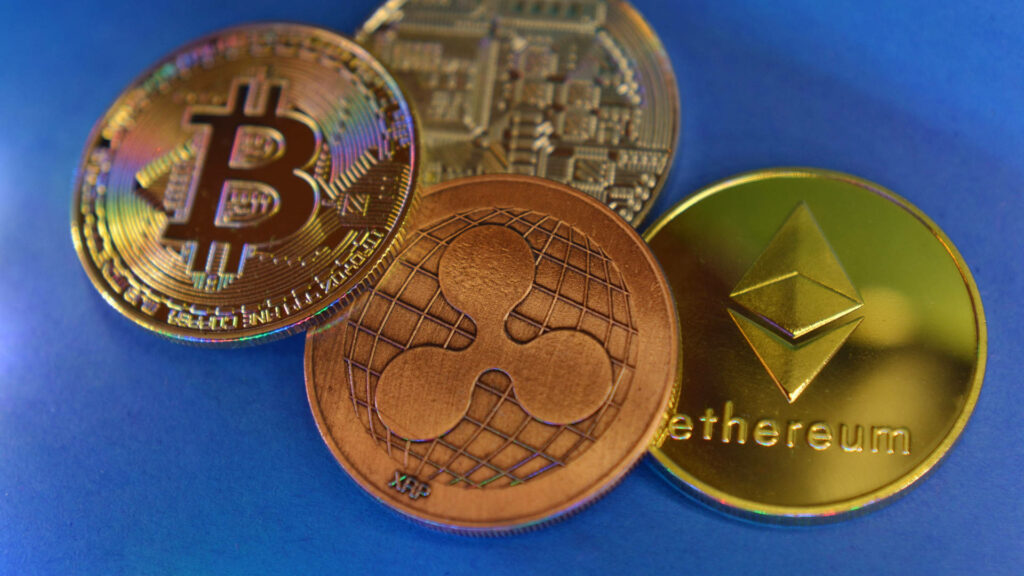 Shiny golden Ethereum Bitcoin Ripple coins on deep blue background cryptocurrency wallpaper