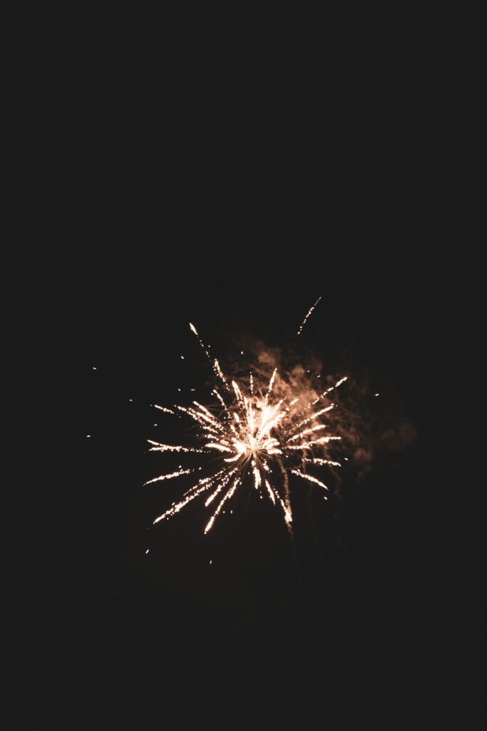 Golden Fireworks Wallpaper: Vibrant Celebration on Dark Background