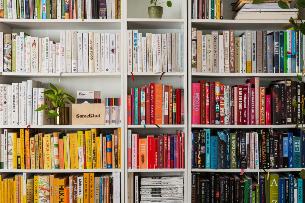 Colorful library bookshelf with books arranged in a vibrant gradient for book lovers wallpaper