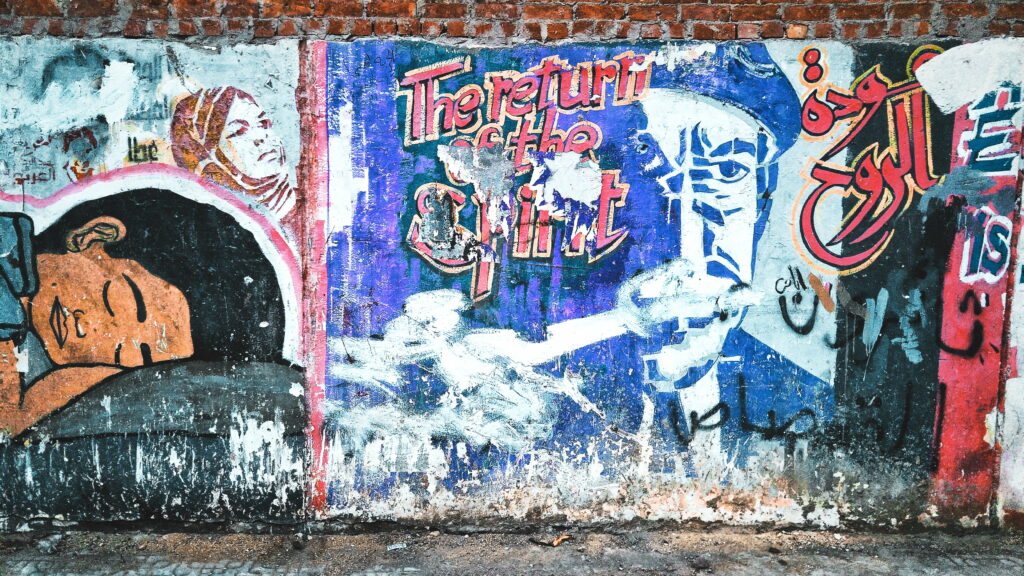Vibrant Urban Expression: HD Wallpaper of Colorful Graffiti Transforming Brick Walls