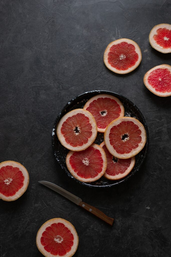 Vibrant Grapefruit Still-Life Wallpaper - Rich Red Hues & Elegance