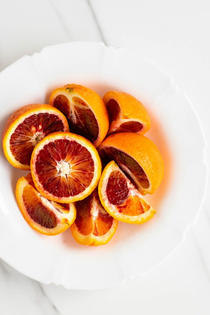 Vibrant Grapefruit Still Life Wallpaper on Minimalist Marble