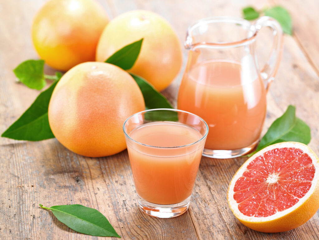 Vibrant Grapefruit Wallpaper: Fresh Juice & Rustic Table Background