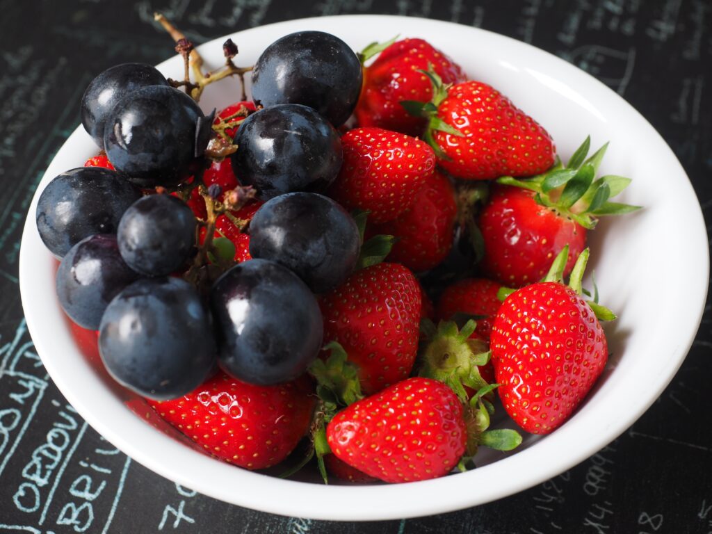 Vibrant Grapes & Ripe Strawberries Wallpaper Background