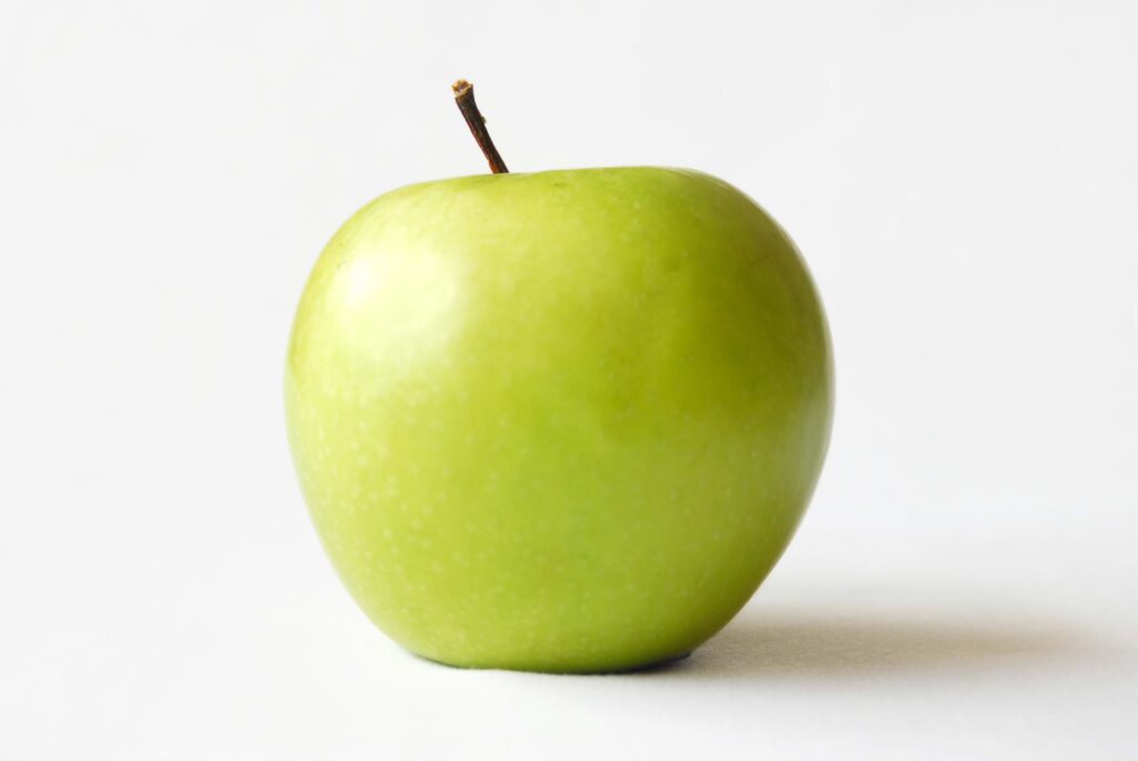 Vibrant Green Apple on White Background - Fresh Wallpaper Wallpaper